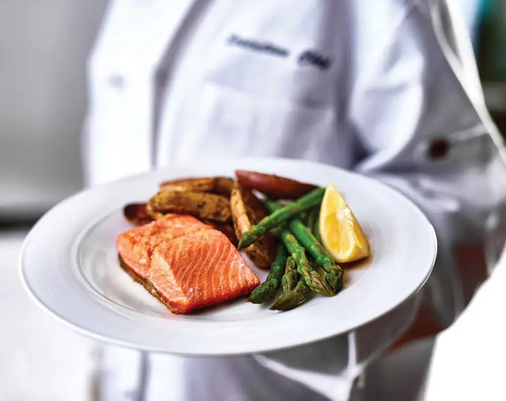 Magnolia Heights Chef Created Meals, chef delivering a finished dish.